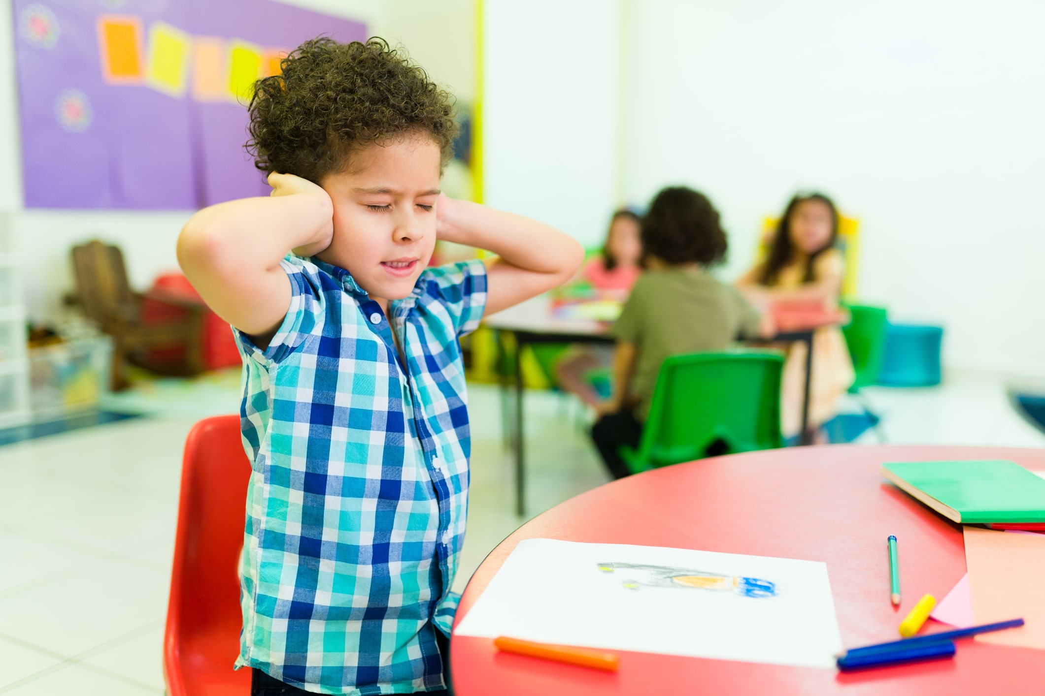 Overwhelmed child with autism in kindergarten