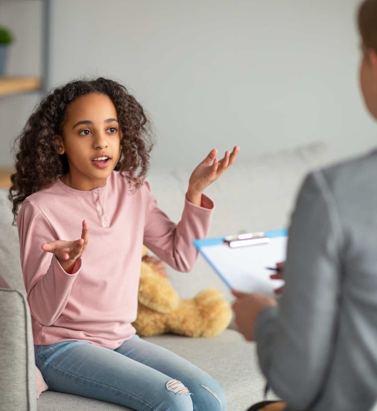 Successful therapy. Teen patient talking to psychologist at her office, expressing emotions