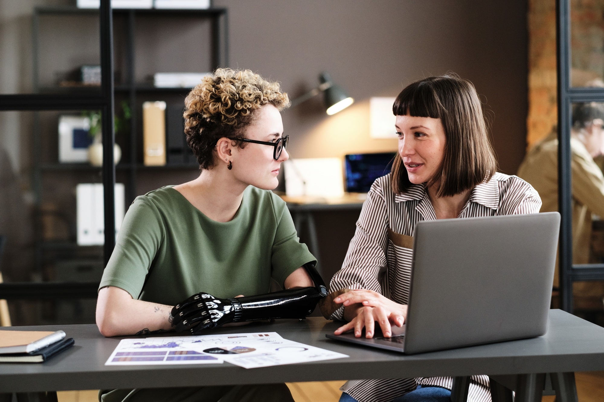 Businesswoman talking to employee at office